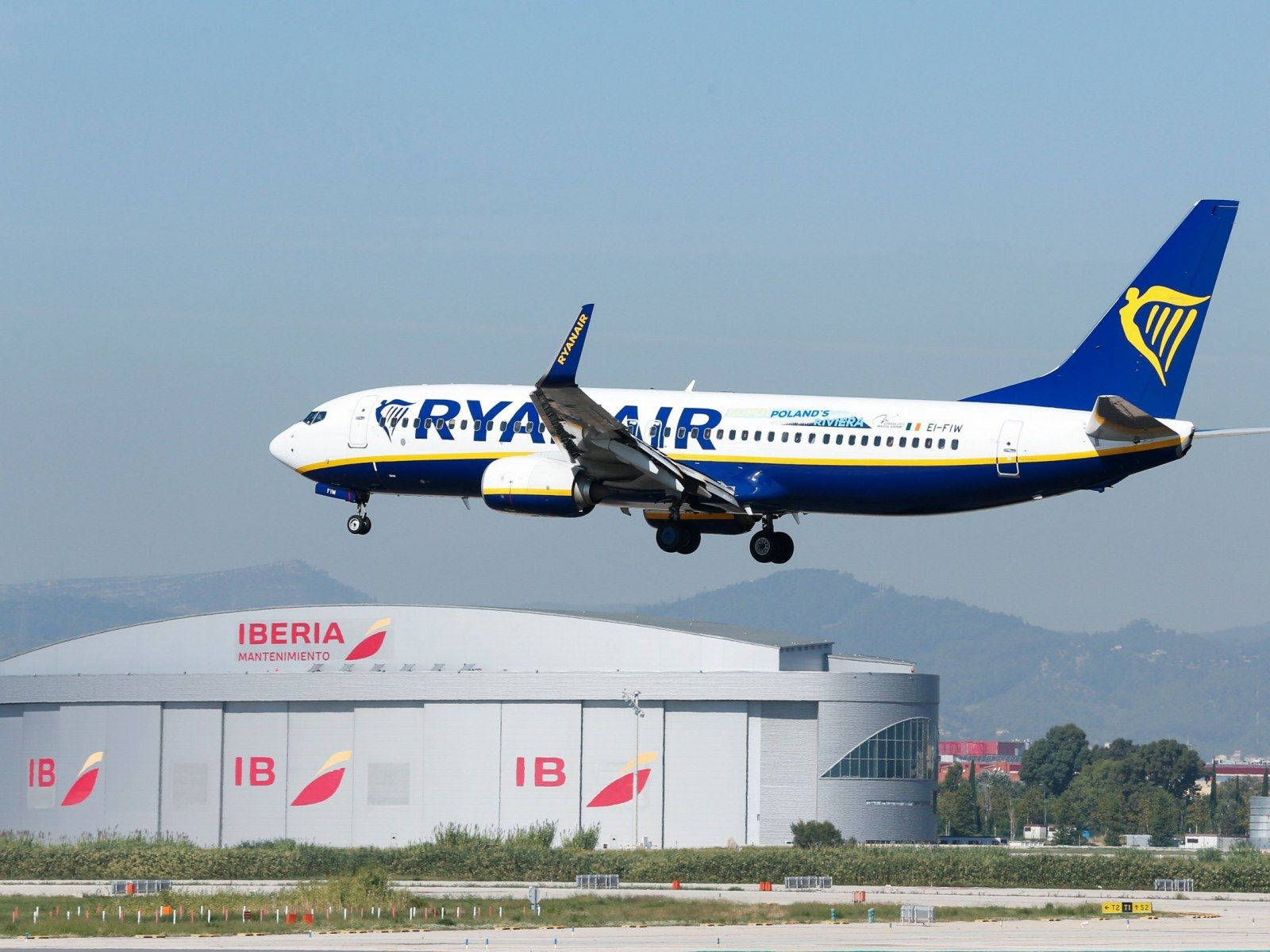 Ryanair Airplane Over Building Background