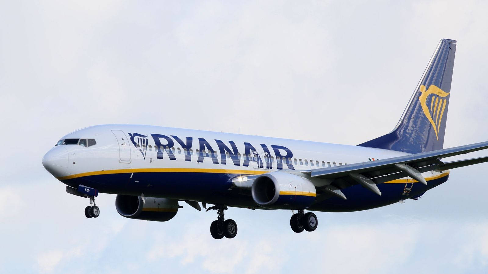 Ryanair Flying In Cloudy Sky Background