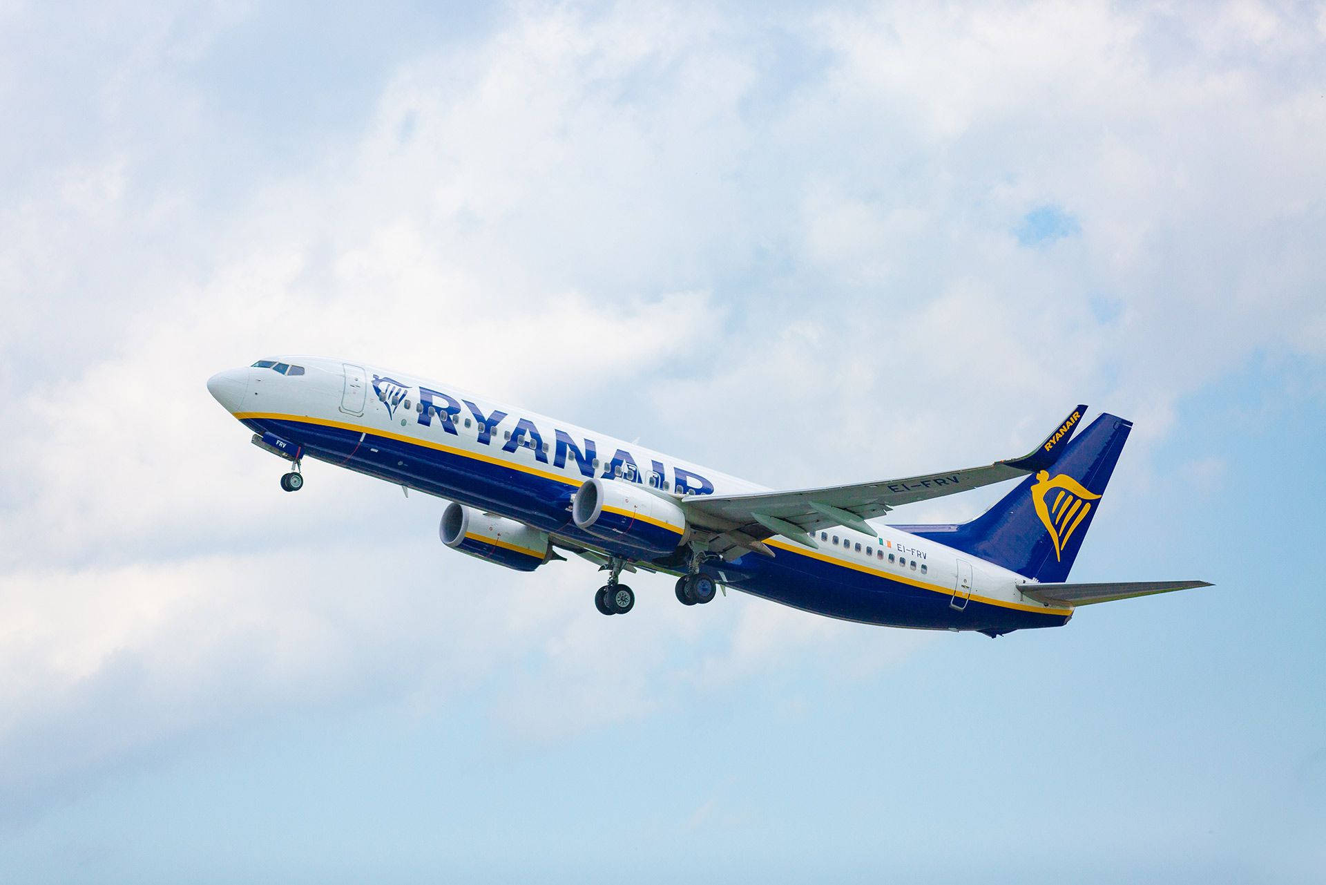 Ryanair Plane Flying In Sky Background