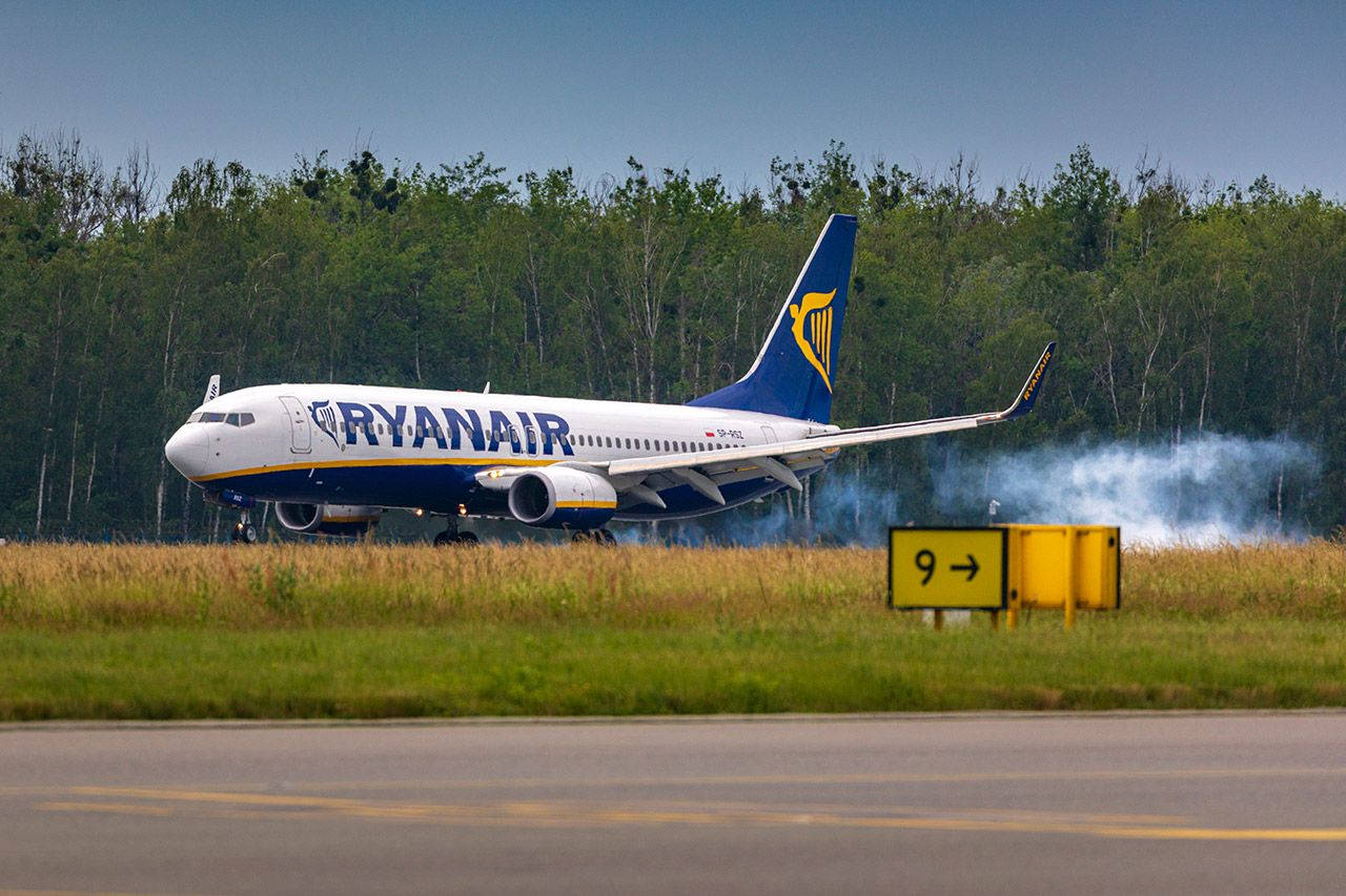 Ryanair With A Forest Background Background