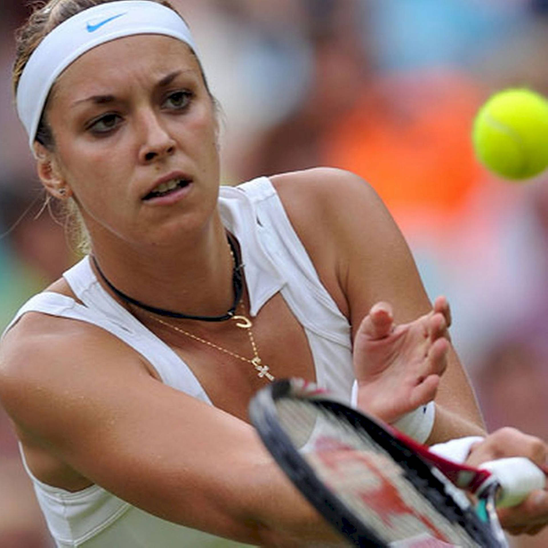 Sabine Lisicki Dynamically Catches The Tennis Ball On The Court Background