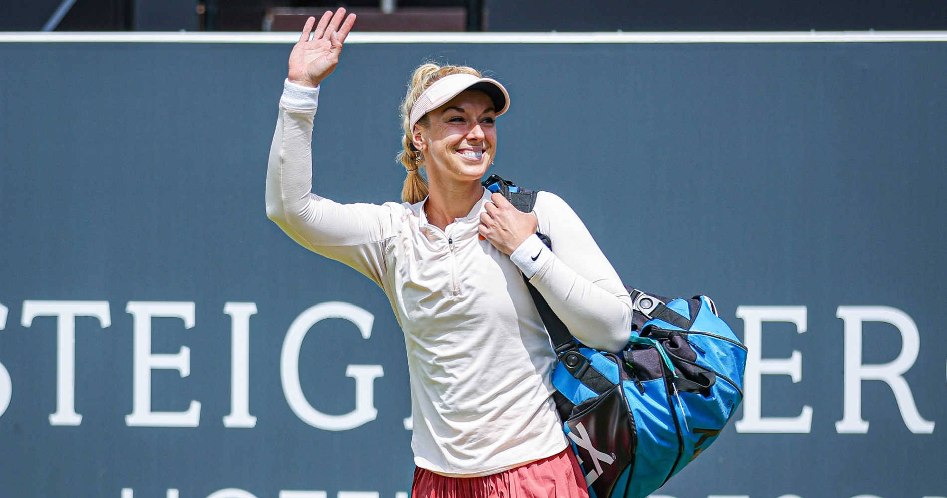 Sabine Lisicki Smiling And Waving Background