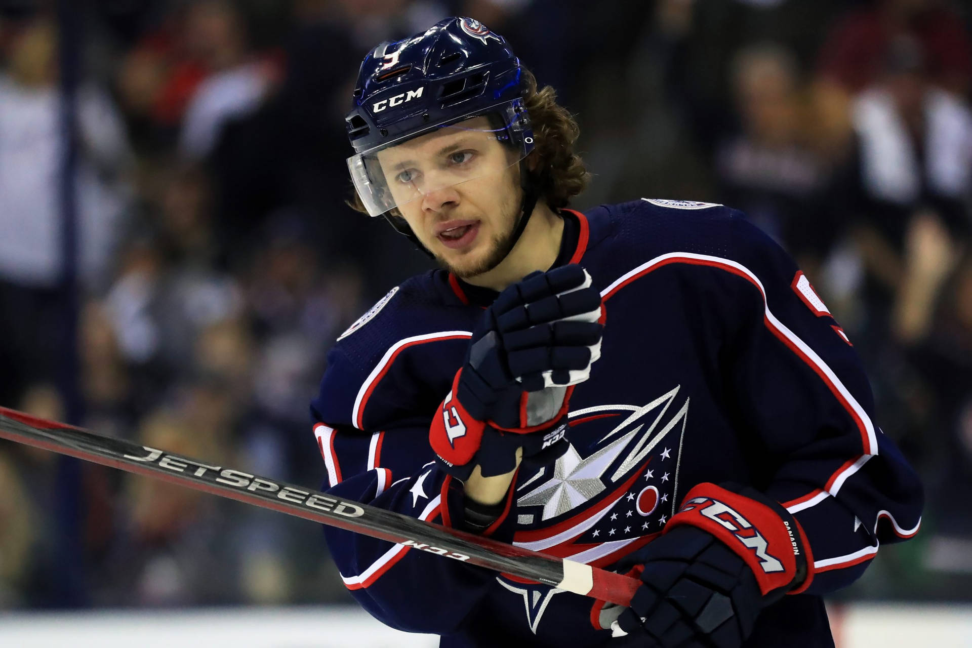 Sad Artemi Panarin Holding A Hockey Stick Background