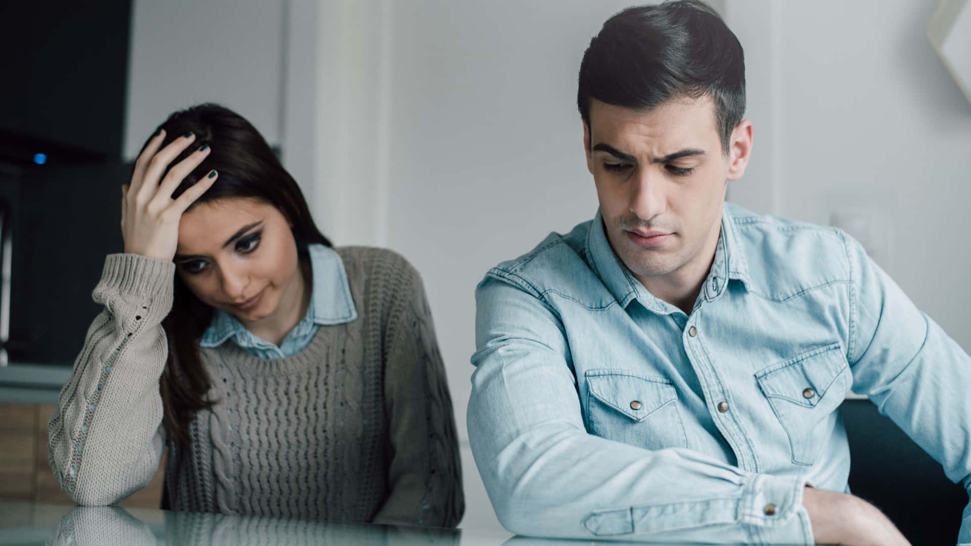 Sad Couple Leaning On The Table Background