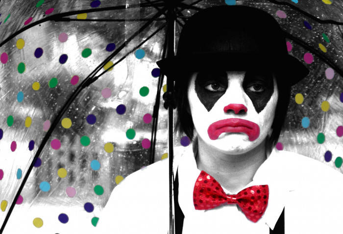 Sad Joker Under An Umbrella Background