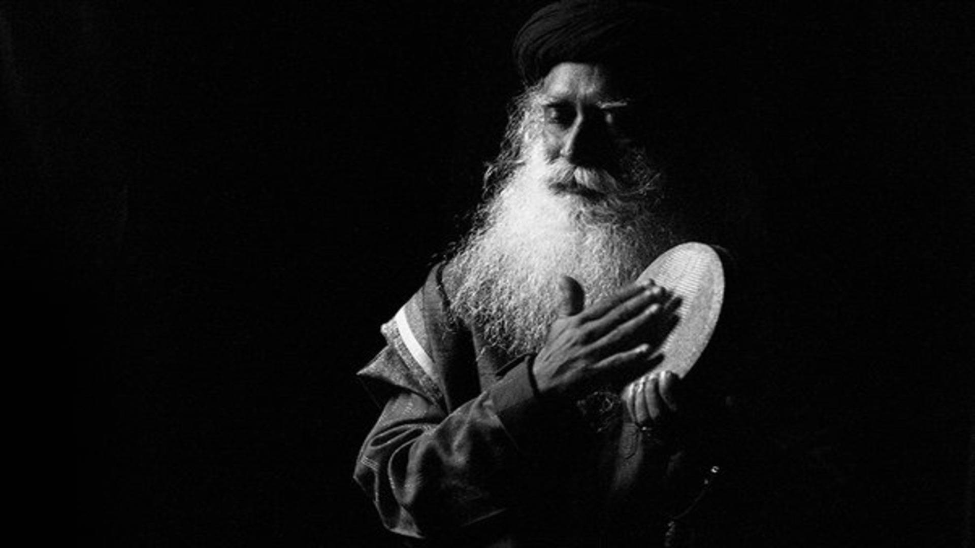 Sadhguru Playing A Kanjira Black And White Background