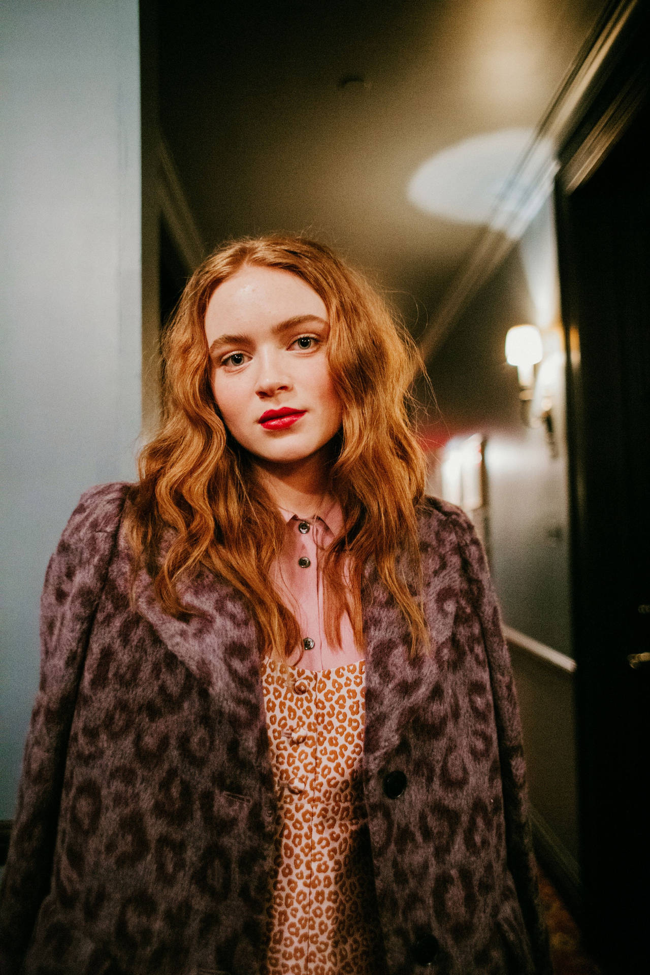 Sadie Sink In A Hotel Background