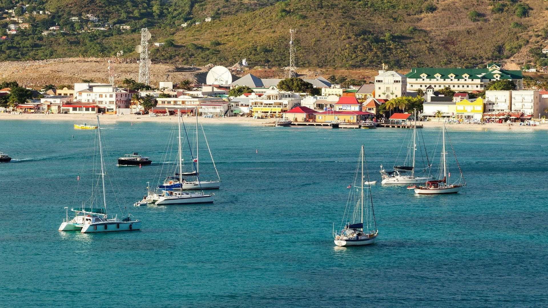 Sailboats On Sint Maarten's Calm Waters Background