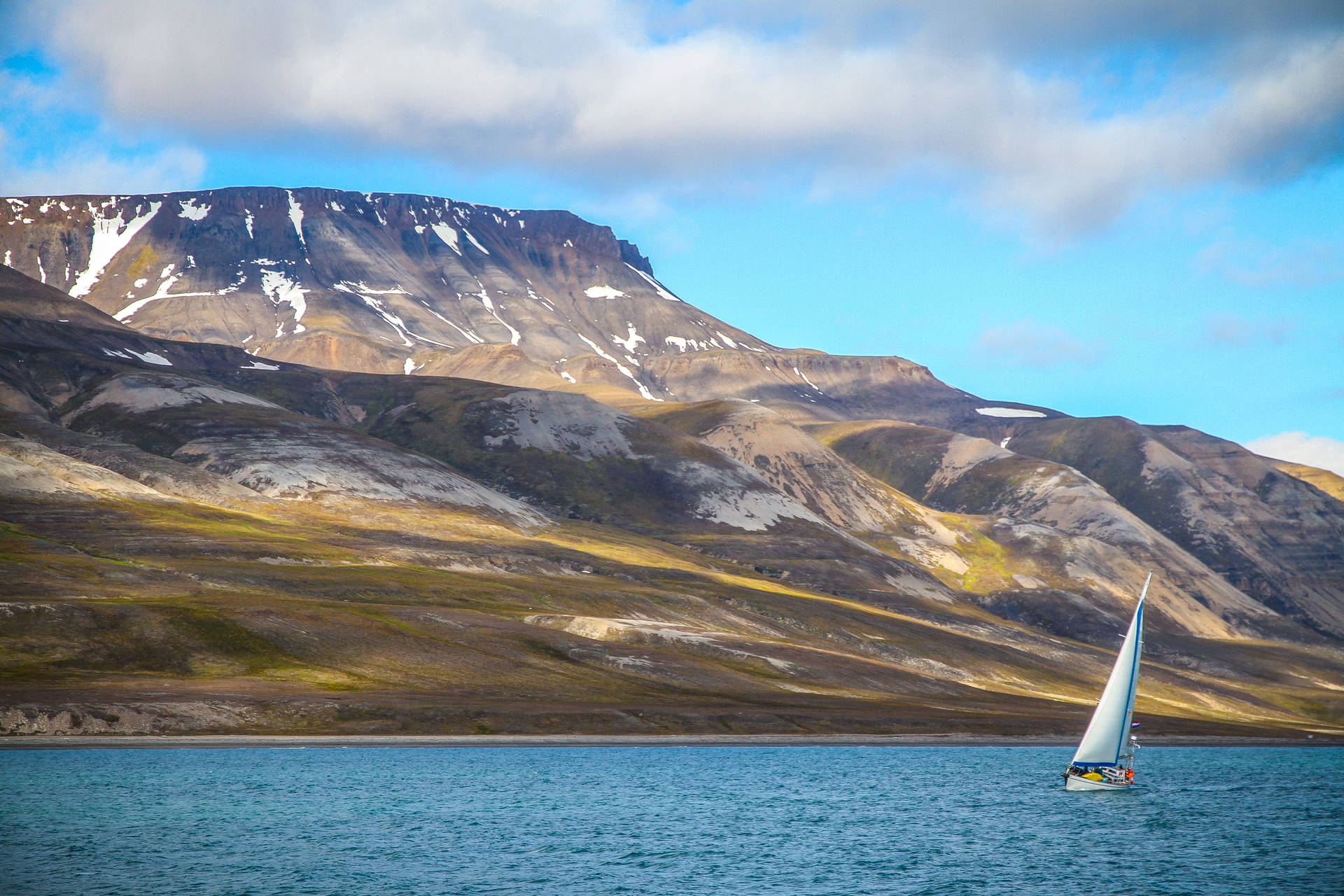 Sailing Boat Against Snow-capped Mountain Background