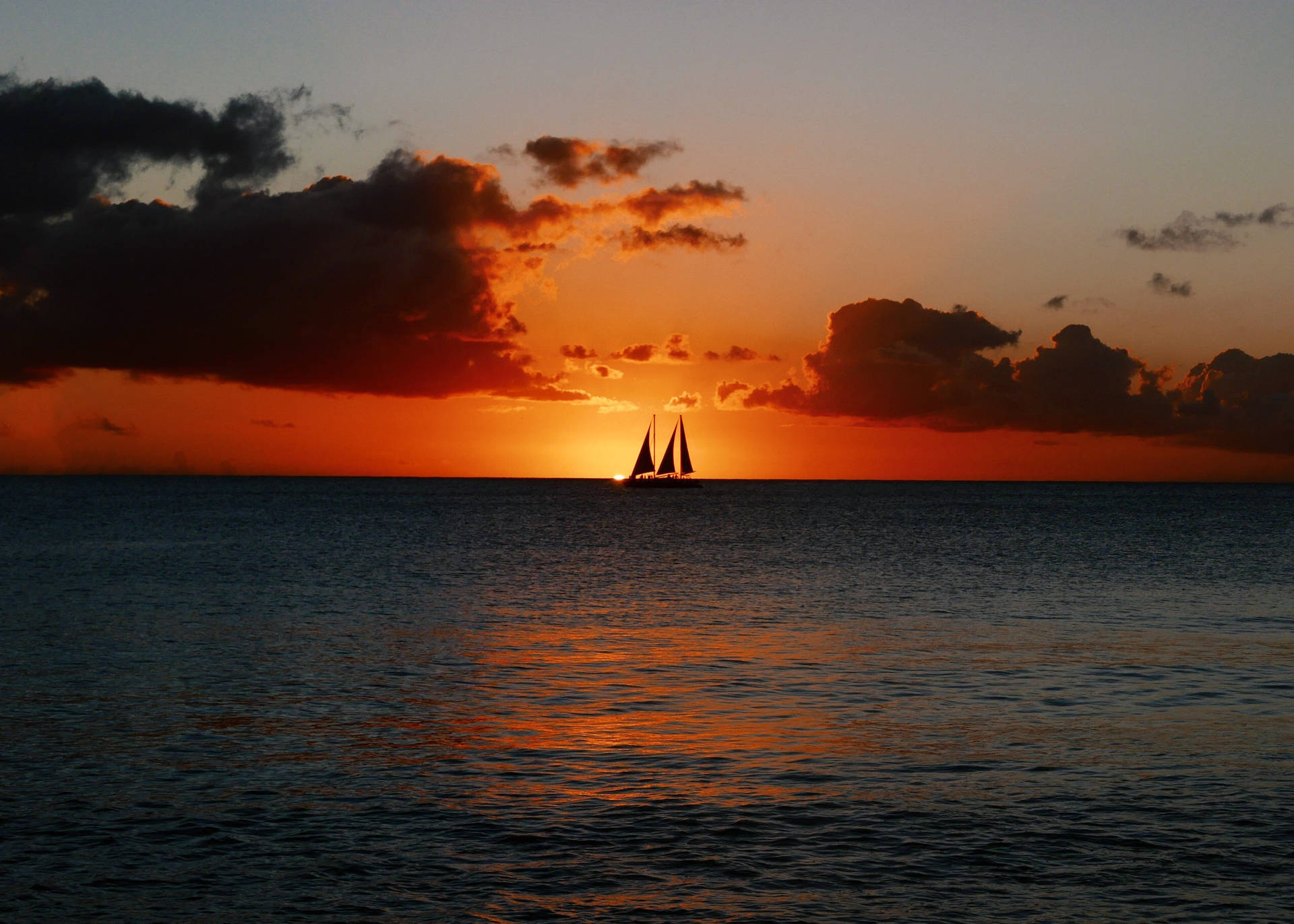 Sailing Sailboat On Ocean's Horizon