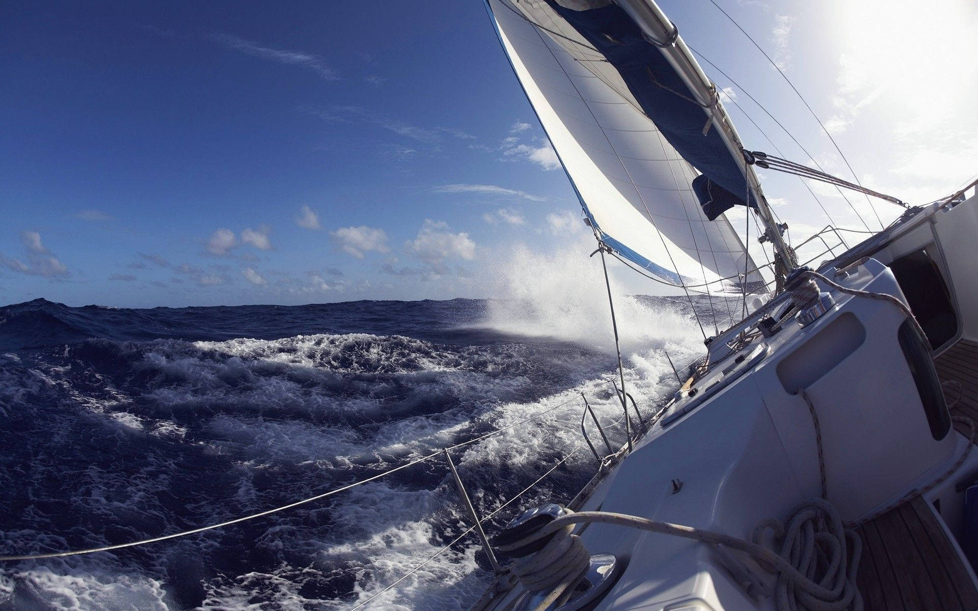Sailing Yacht Braving Waves Background