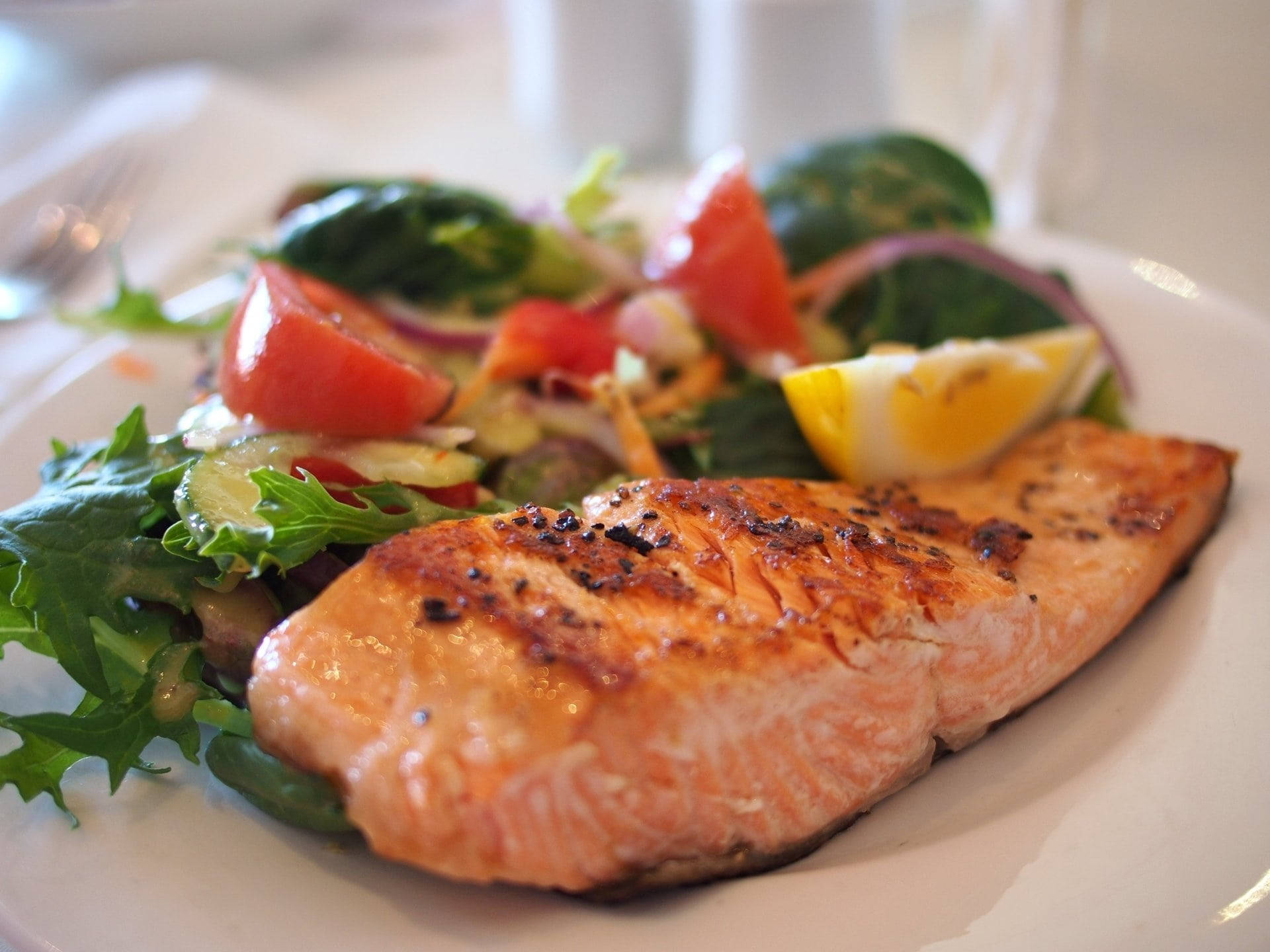 Salmon Dish With Vegetables And Lemon Slices Background