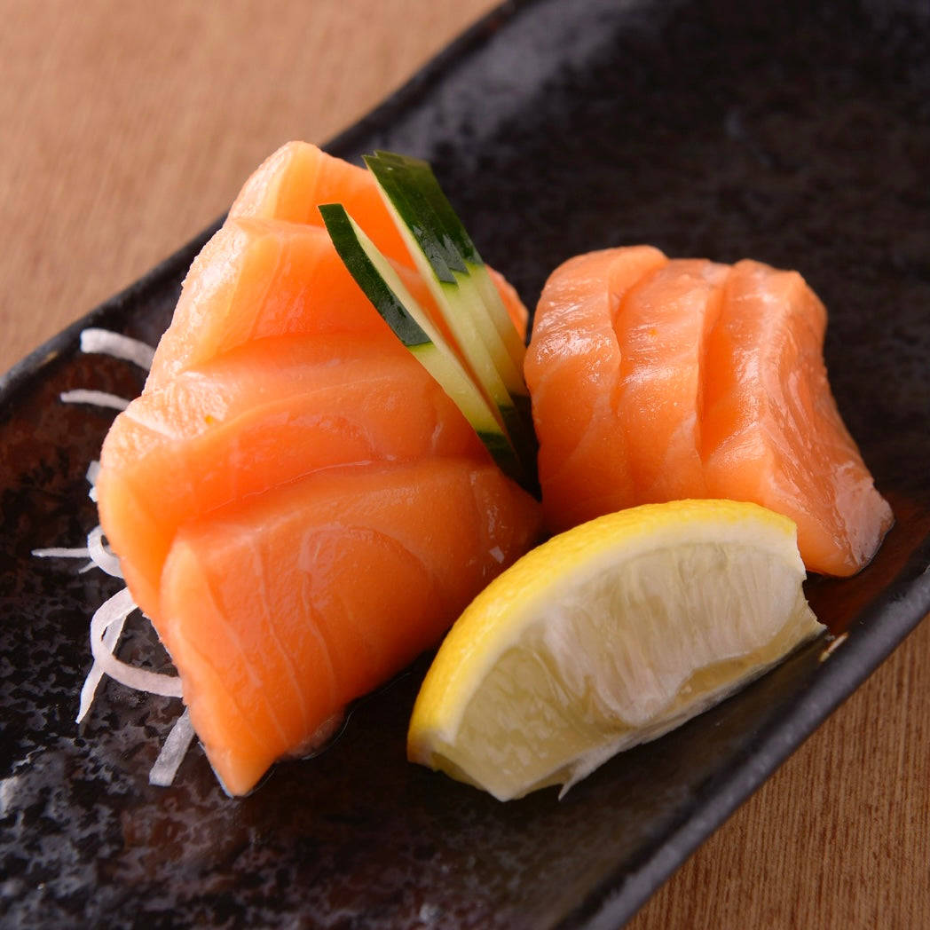 Salmon Sashimi With Cucumber And Lemon Background