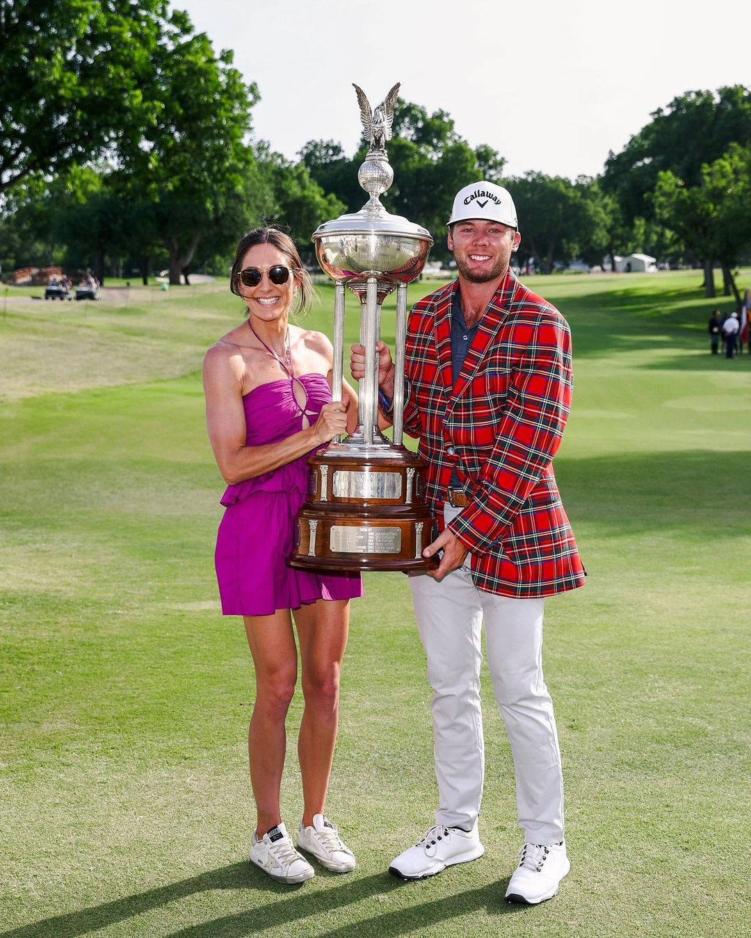 Sam Burns And Wife Holding Trophy Background