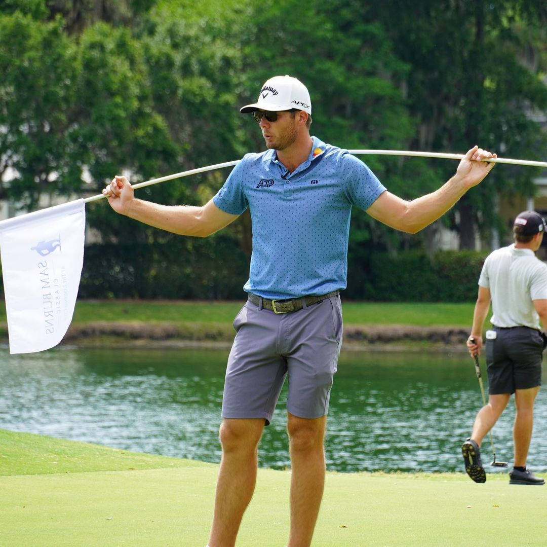 Sam Burns Carrying White Golf Flag Background