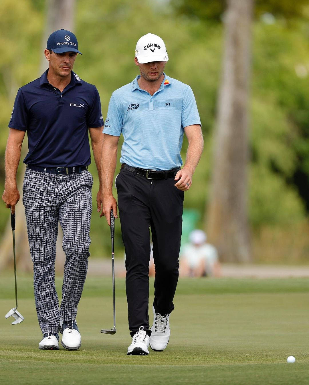 Sam Burns Walking With Fellow Golfer Background