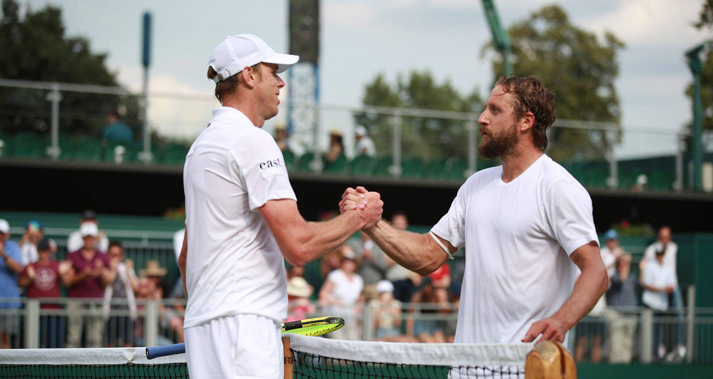 Sam Querrey Offering A Handshake Post-match On The Tennis Court Background