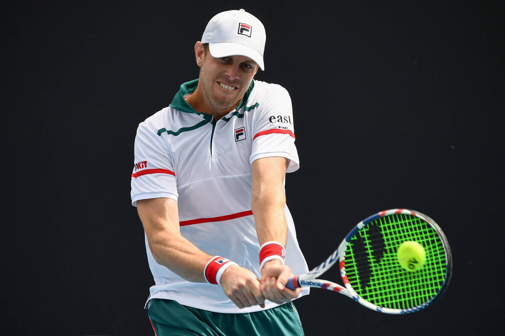 Sam Querrey Performing Iconic Backhand Stroke In Tennis Background