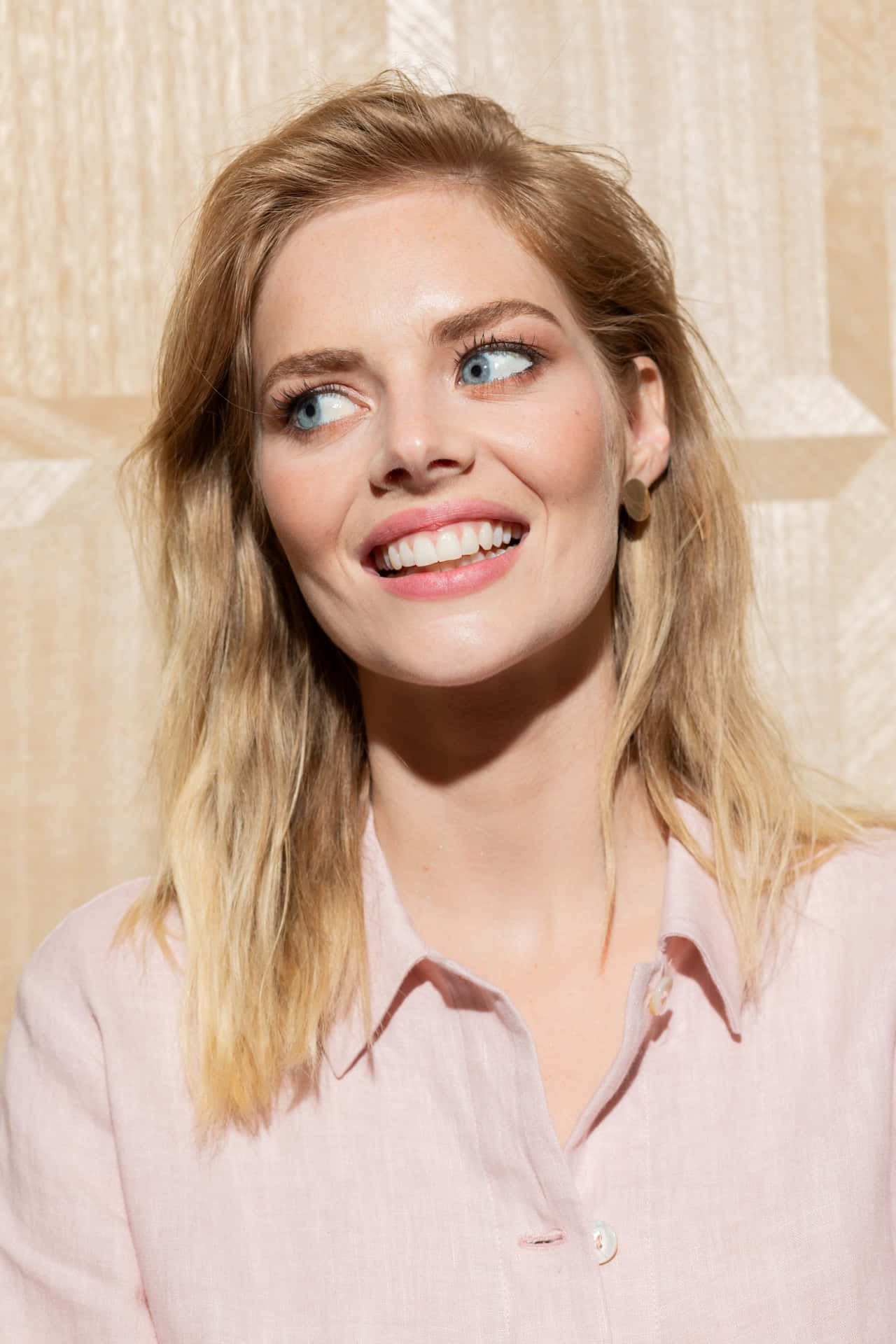 Samara Weaving Pink Blouse Smiling Background