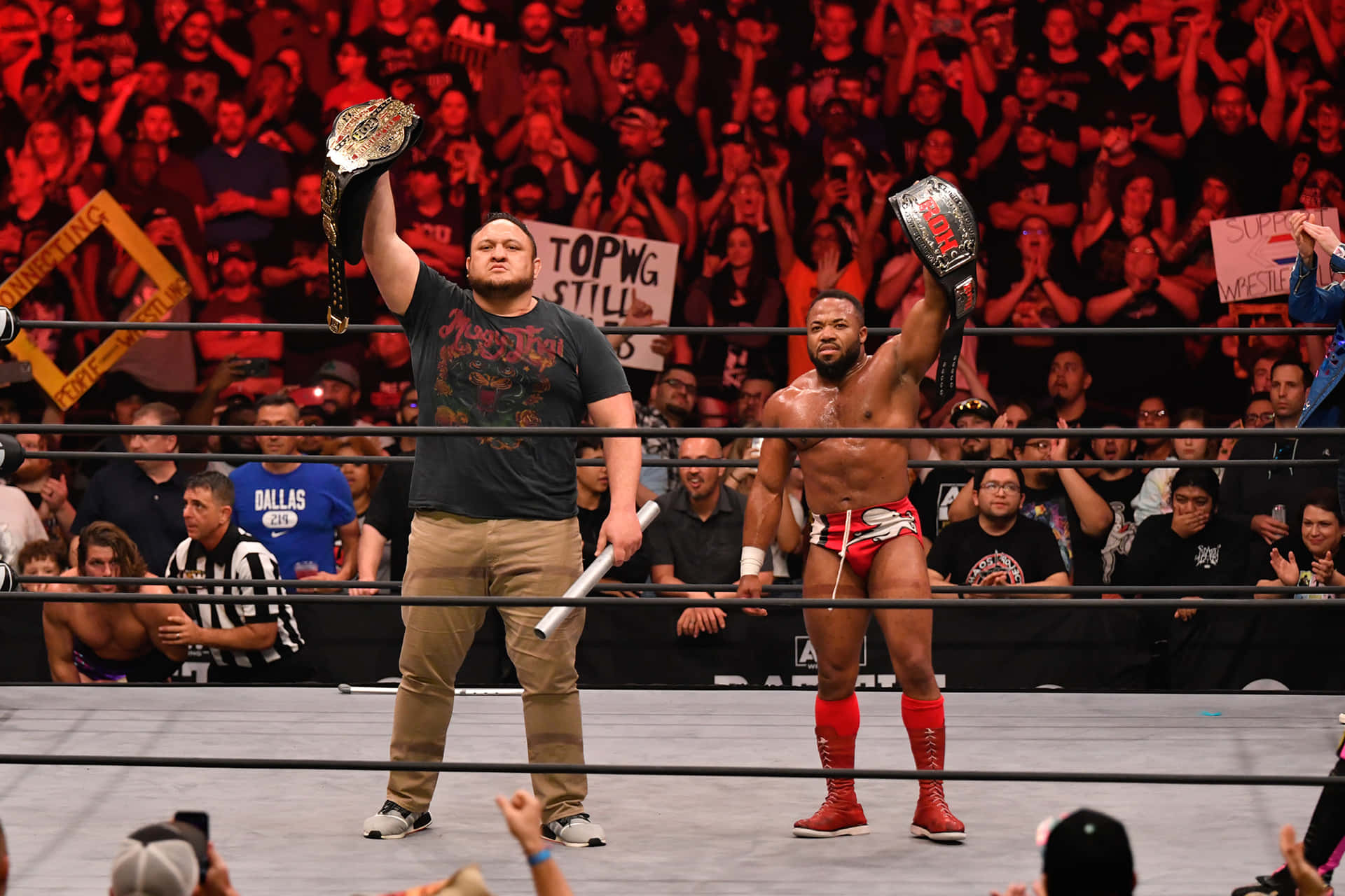 Samoa Joe And Jonathan Gresham Holding Championships Background