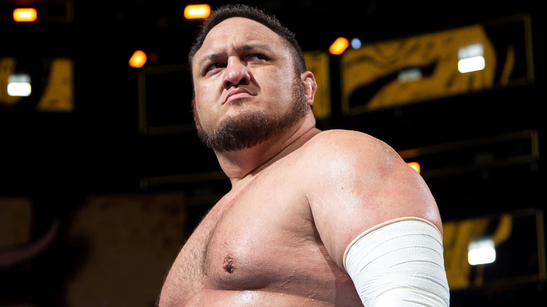 Samoa Joe Showcasing His Fierce Persona In An Aew Match Background