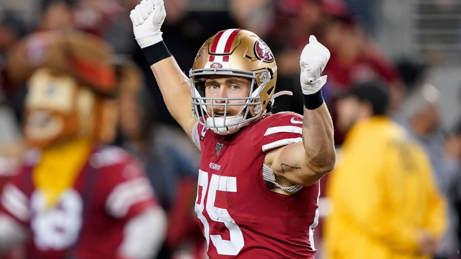San Francisco 49ers Tight End George Kittle Adjusting To Catch A Pass During A Game. Background