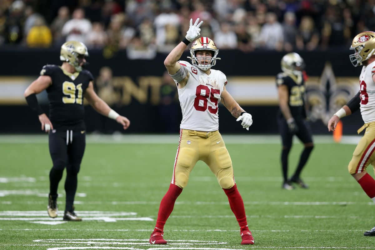 San Francisco 49ers Tight End George Kittle Explodes Into The End Zone Background