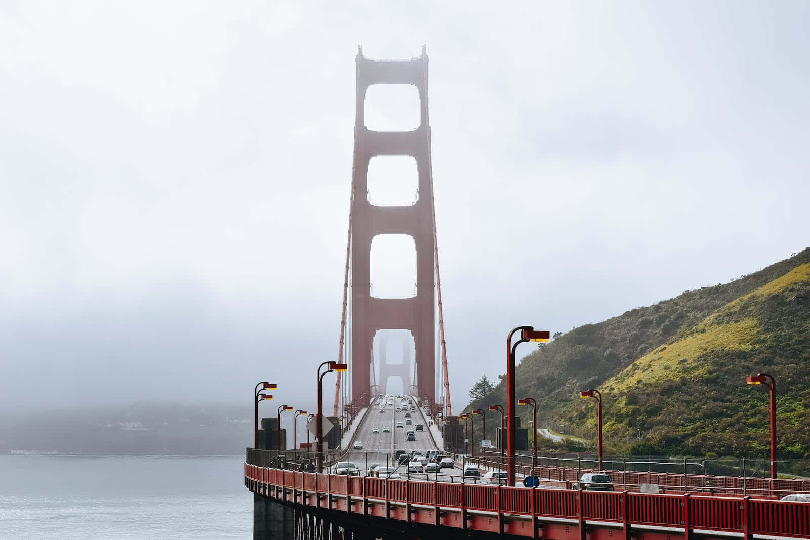 San Francisco’s Iconic Fog Rolling Over The Bay Bridge. Background