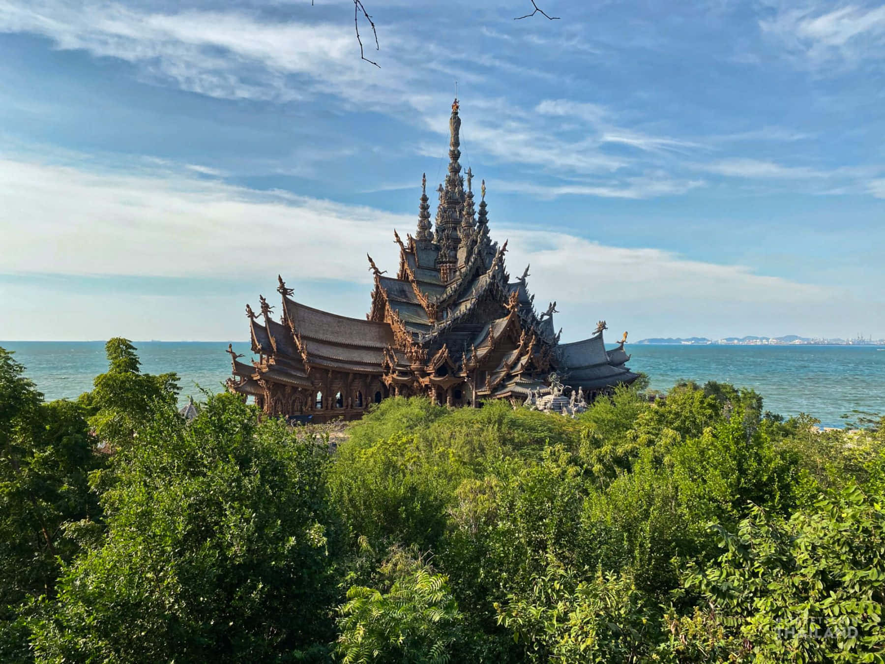 Sanctuary Of Truth Poking Out From The Forest Background