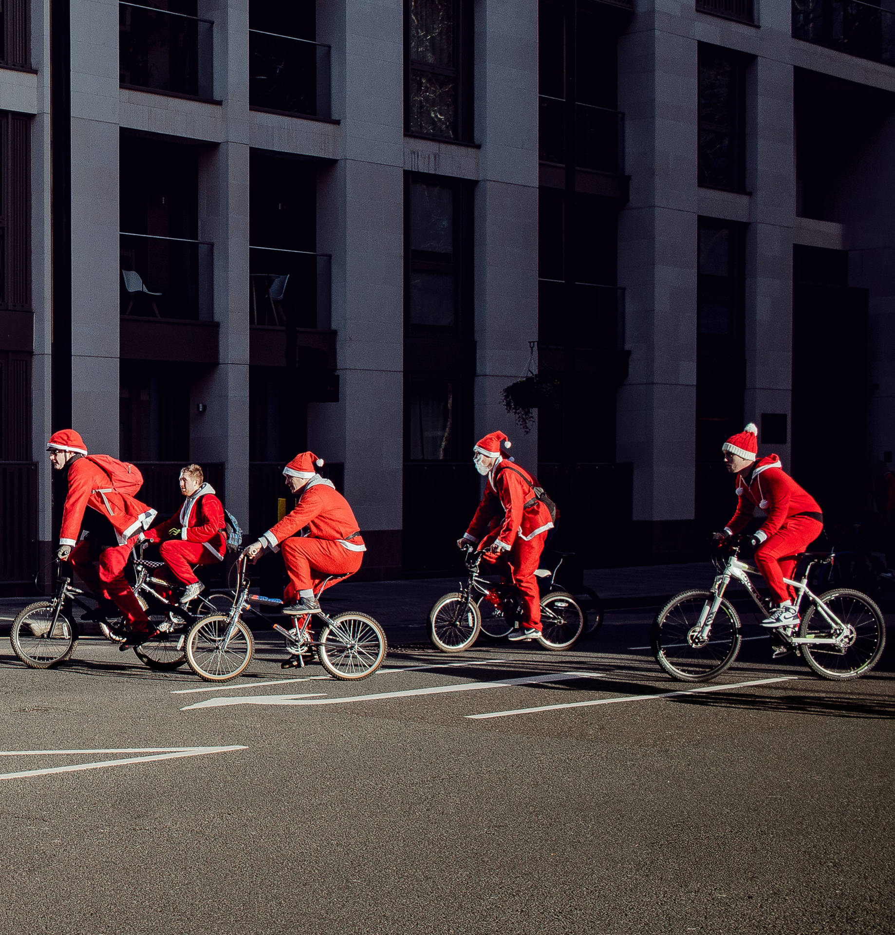 Santa Claus Taking A Break And Enjoying A Breezy Bike Ride Background