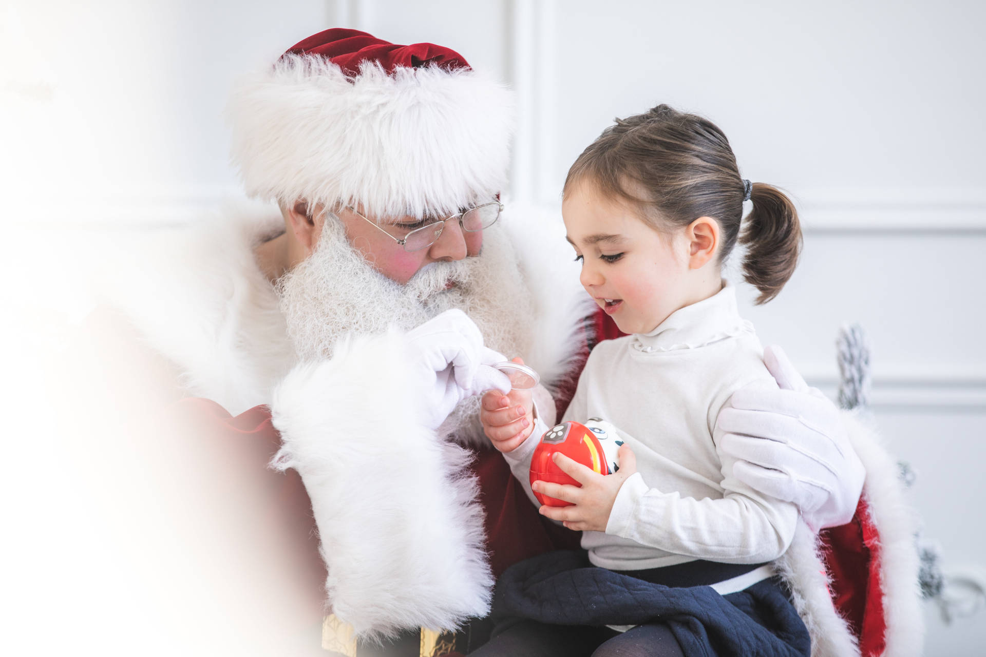 Santa Giving Toy To A Girl Background