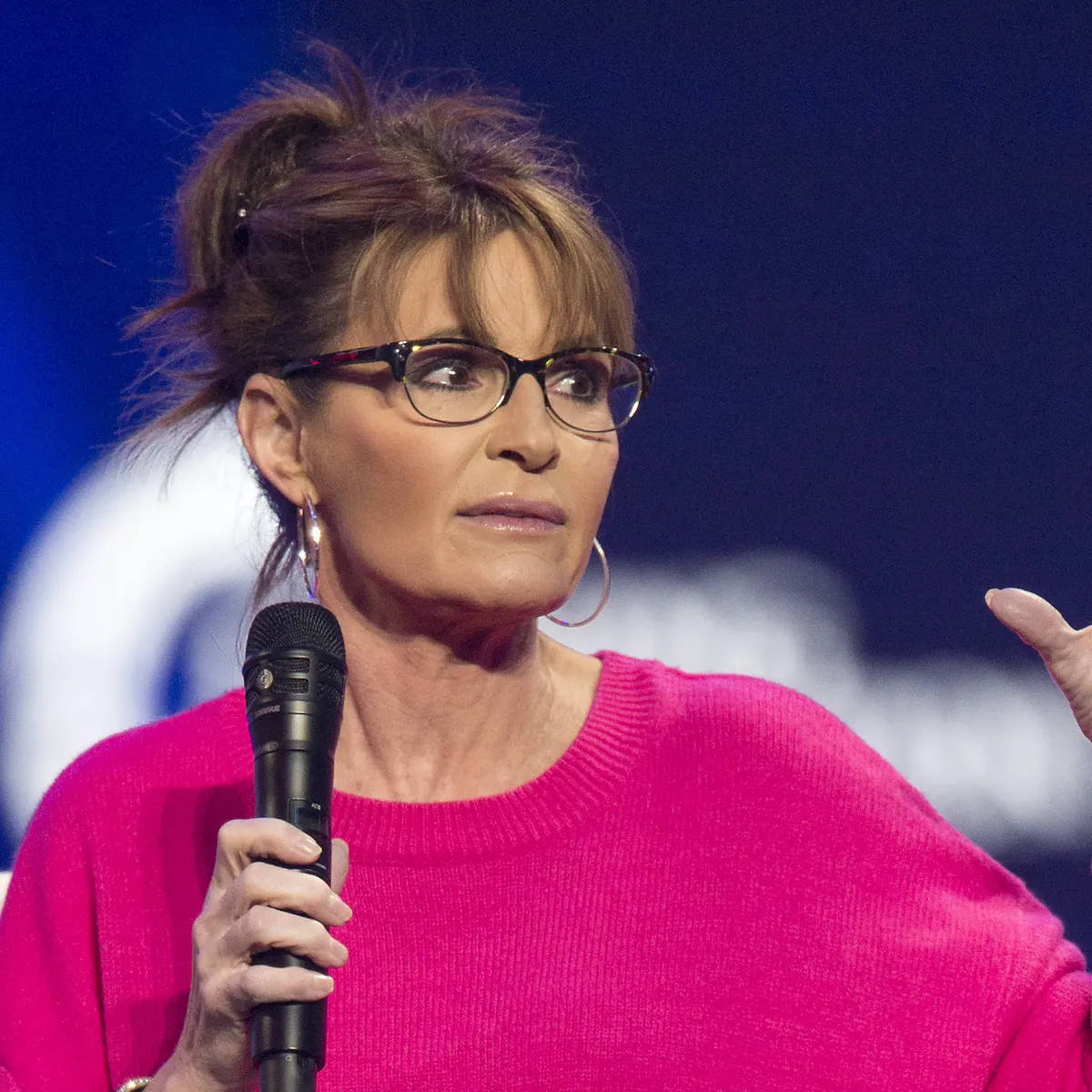 Sarah Palin Posing In A Pink Sweater Background