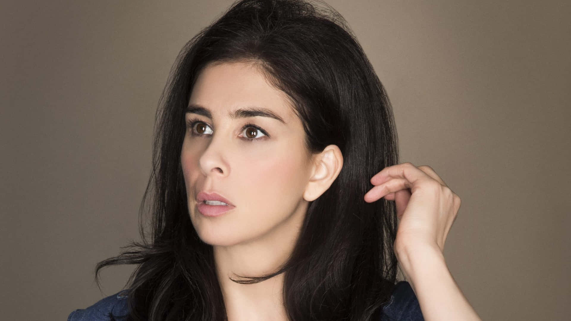 Sarah Silverman Striking A Pose On A Pink Background Background