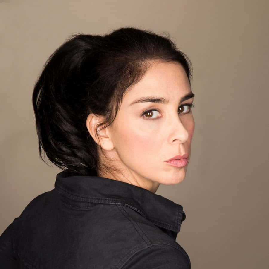 Sarah Silverman Striking A Pose On A Red Background Background