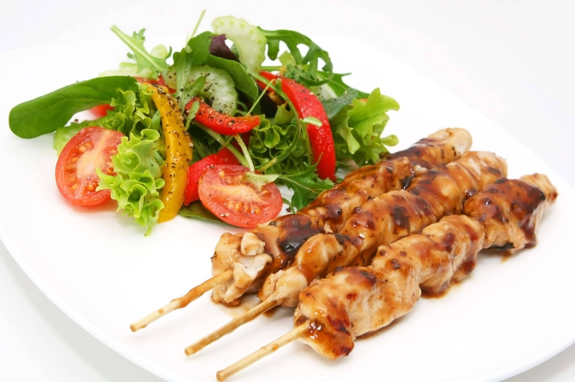 Satay Skewers With Green Salad Background