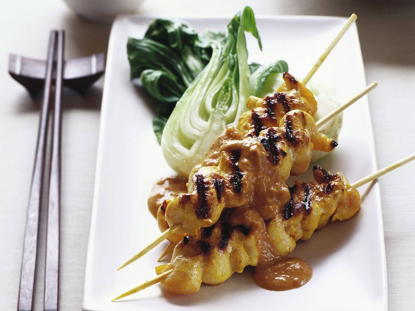 Satay With Bok Choy Vegetables And Chopsticks Background