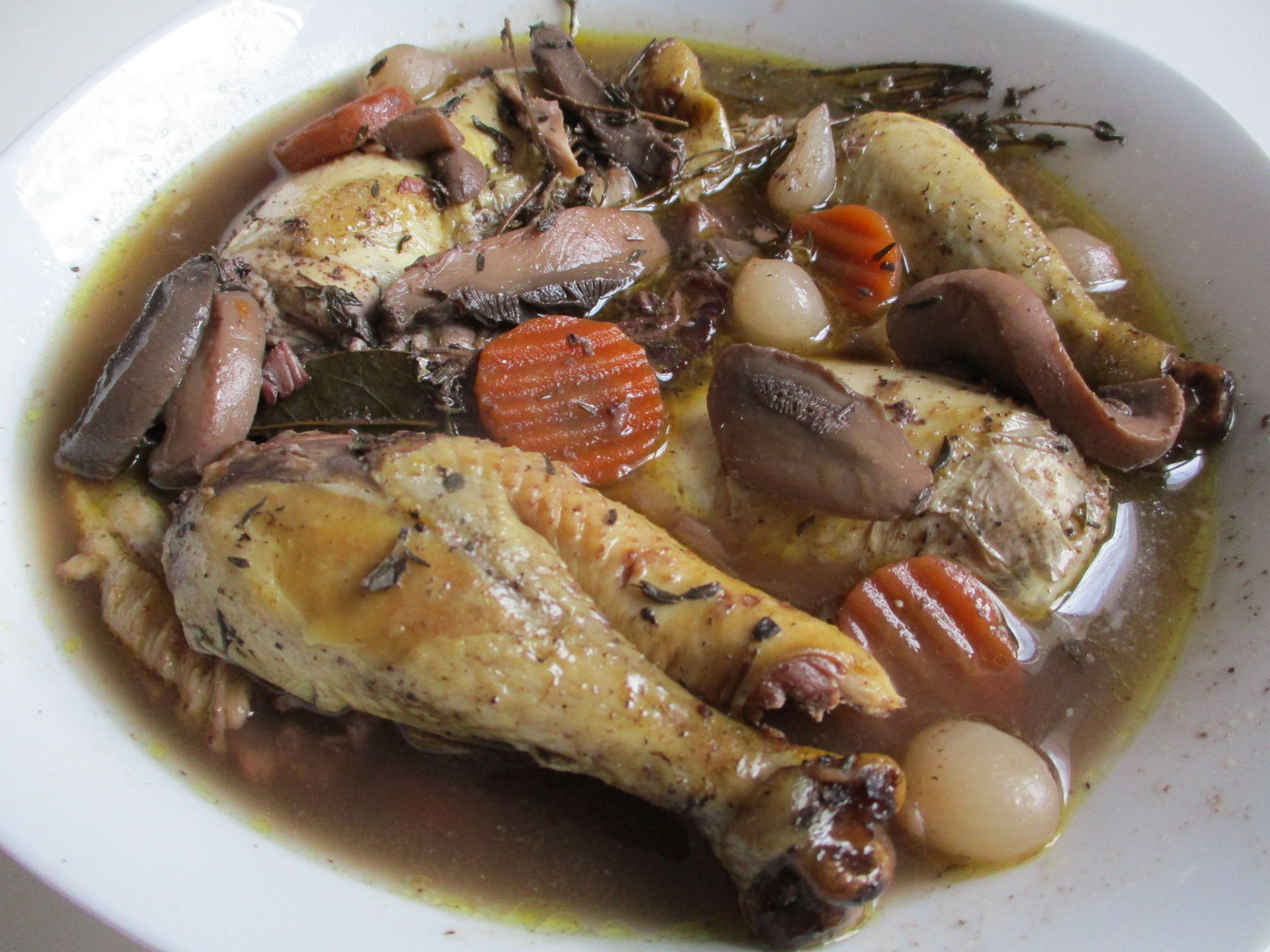 Saucy Coq Au Vin On A Bowl Background