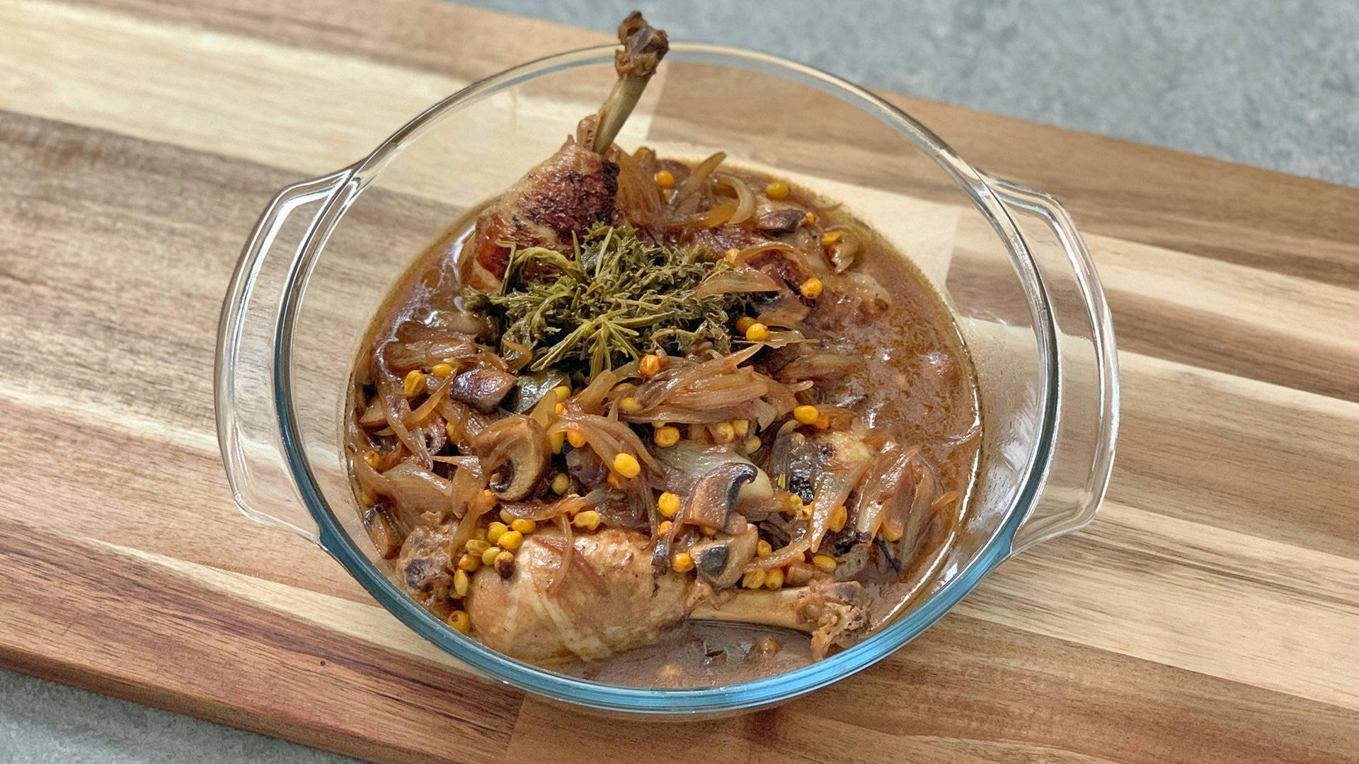 Saucy Coq Au Vin Served On A Glass Bowl Background