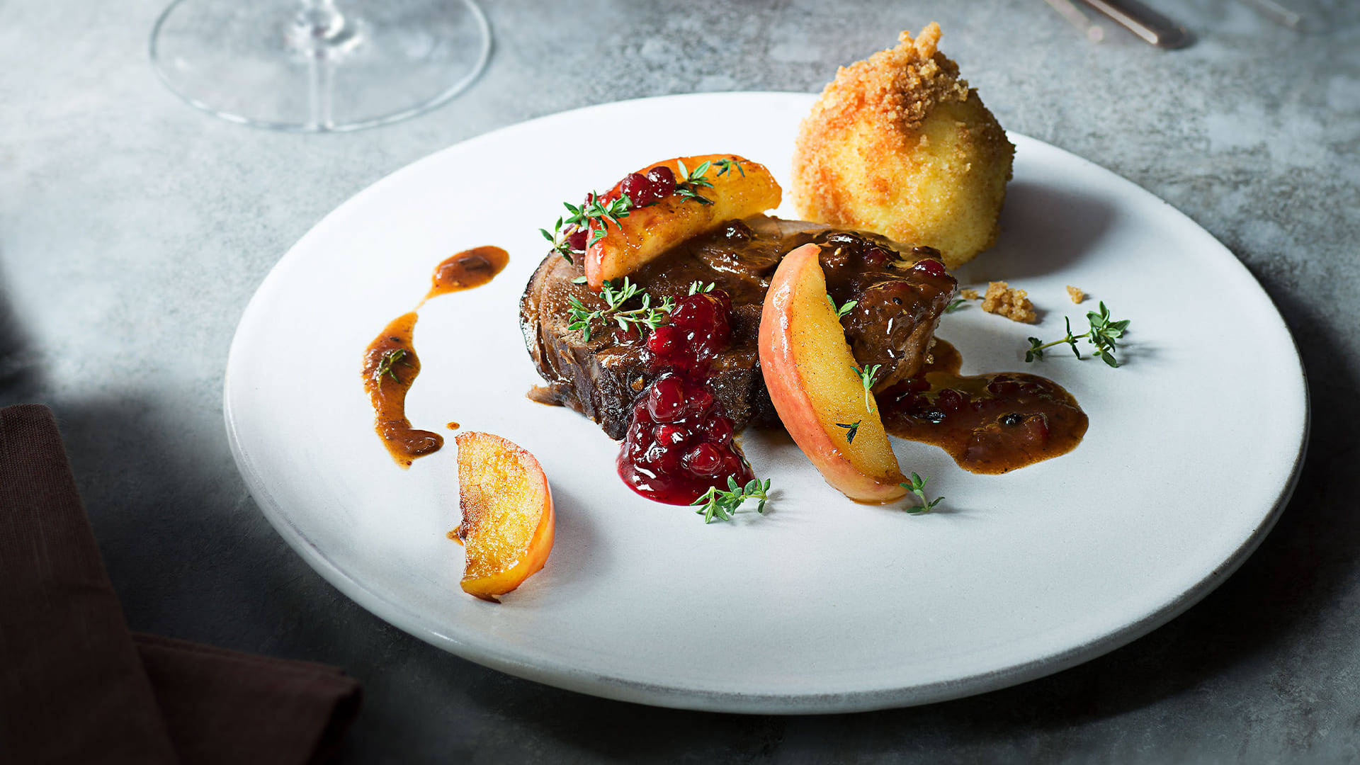 Sauerbraten - A Traditional German Dish Served With Pomegranate Sauce Background