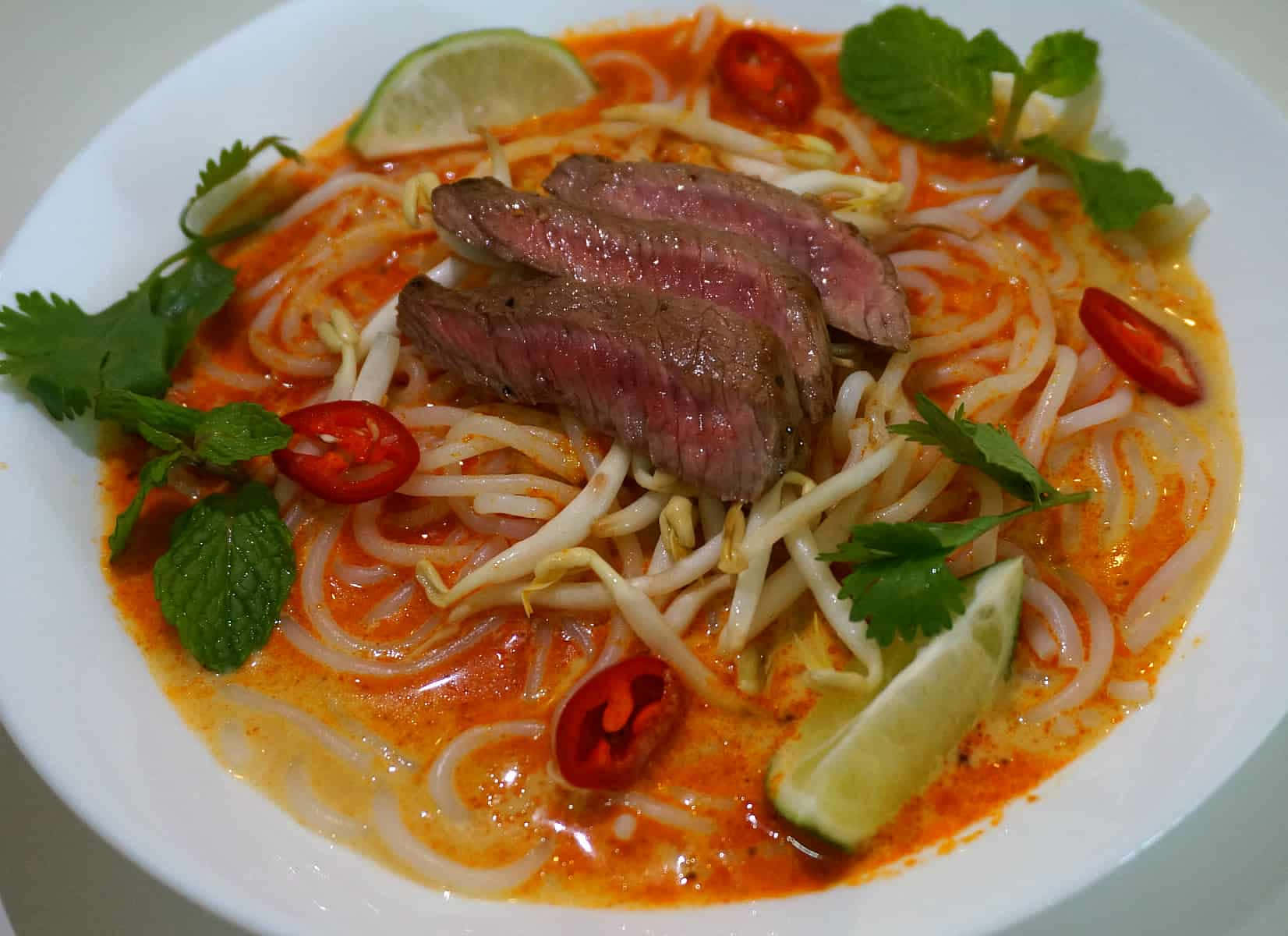 Savoring Authentic Curry Laksa With Medium-rare Beef