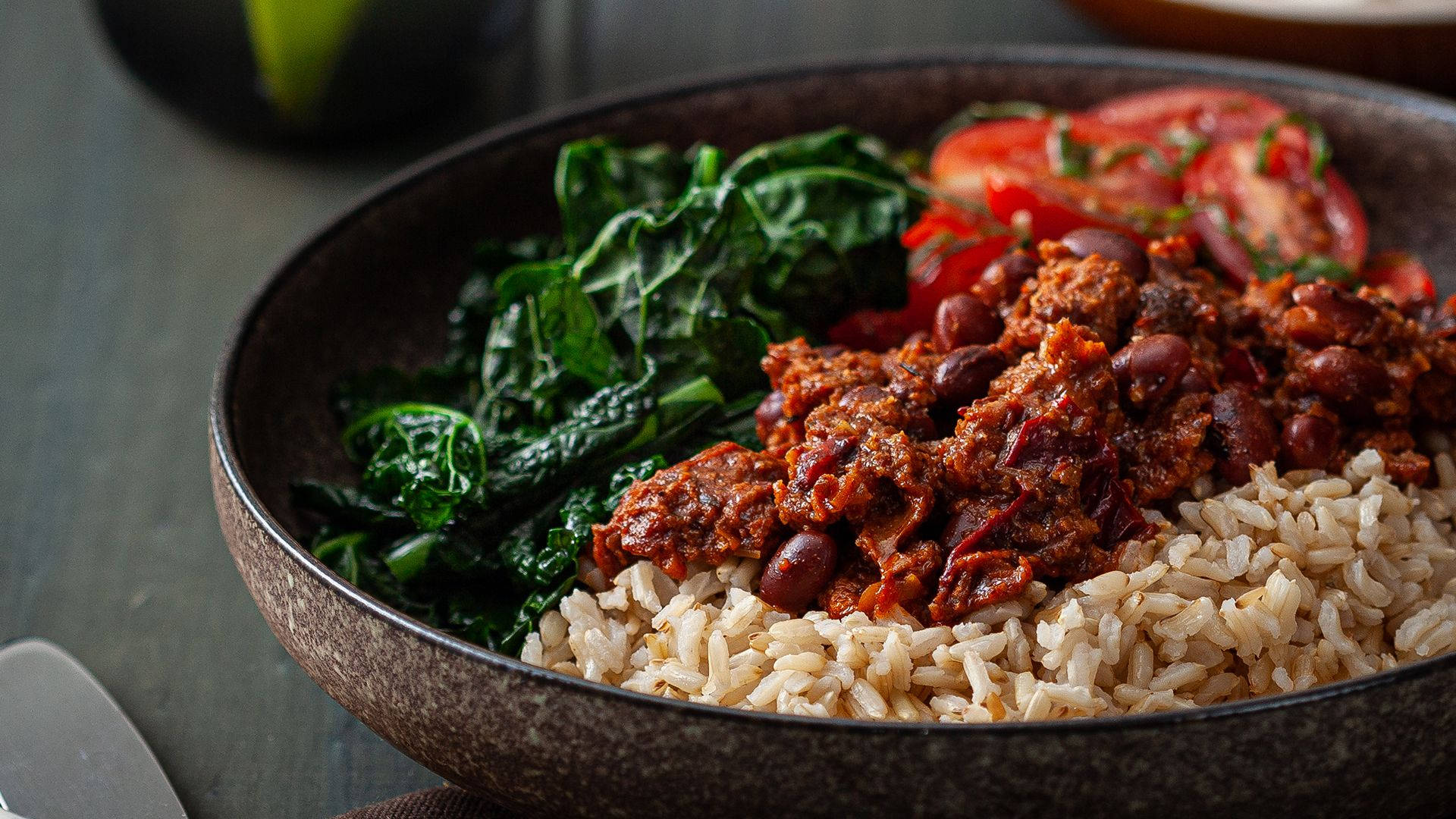 Savory And Hearty Bowl Of Chili Con Carne Served With Rice Background