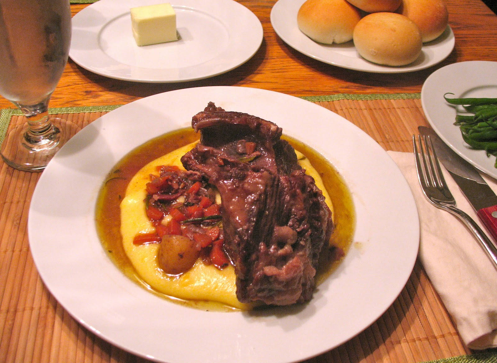 Savory Beef Over Golden Polenta Background