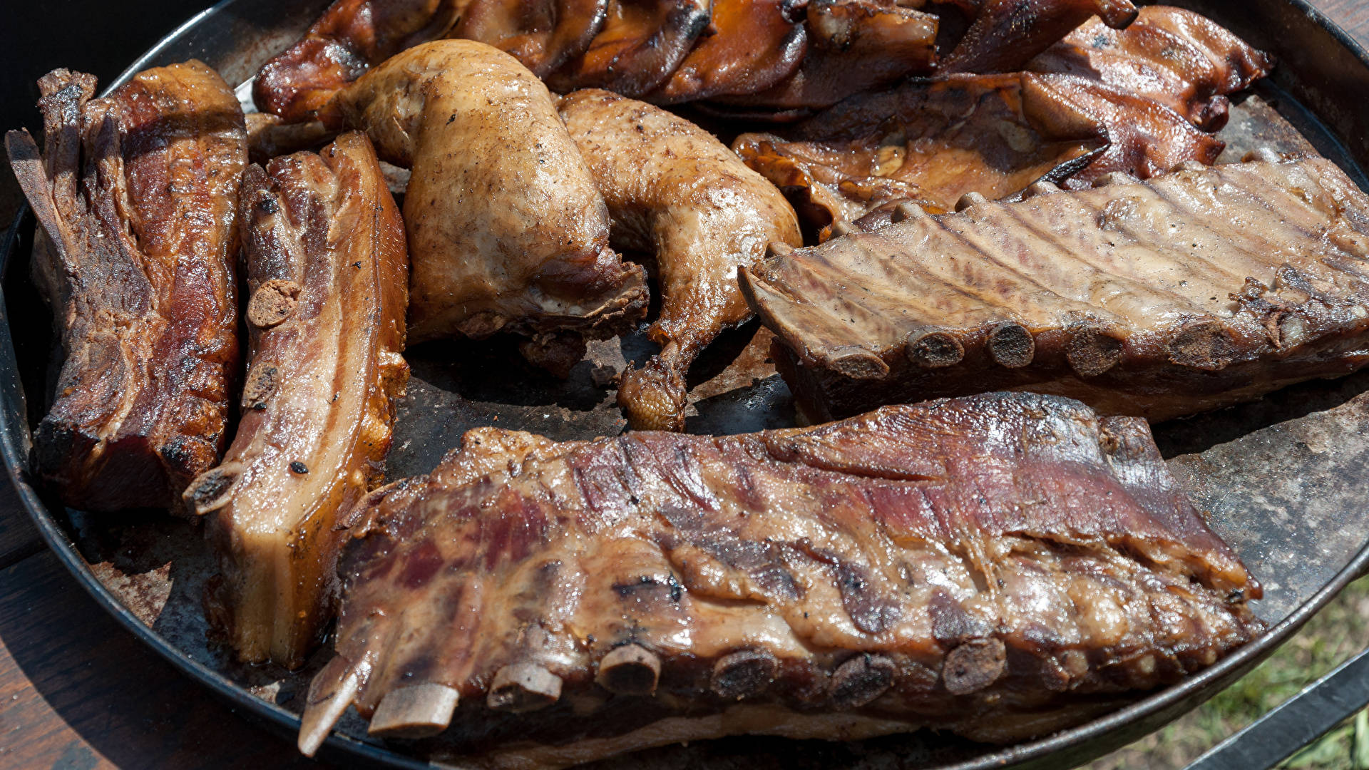 Savory Chicken And Pork Parrilla Cooking On An Open Grill Background