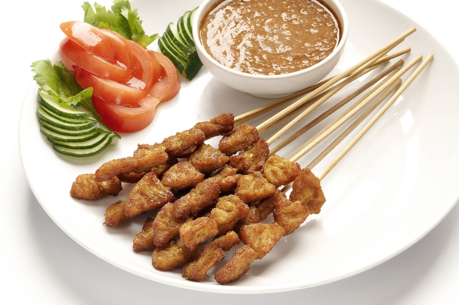 Savory Chicken Satay On A Tranquil White Plate Background