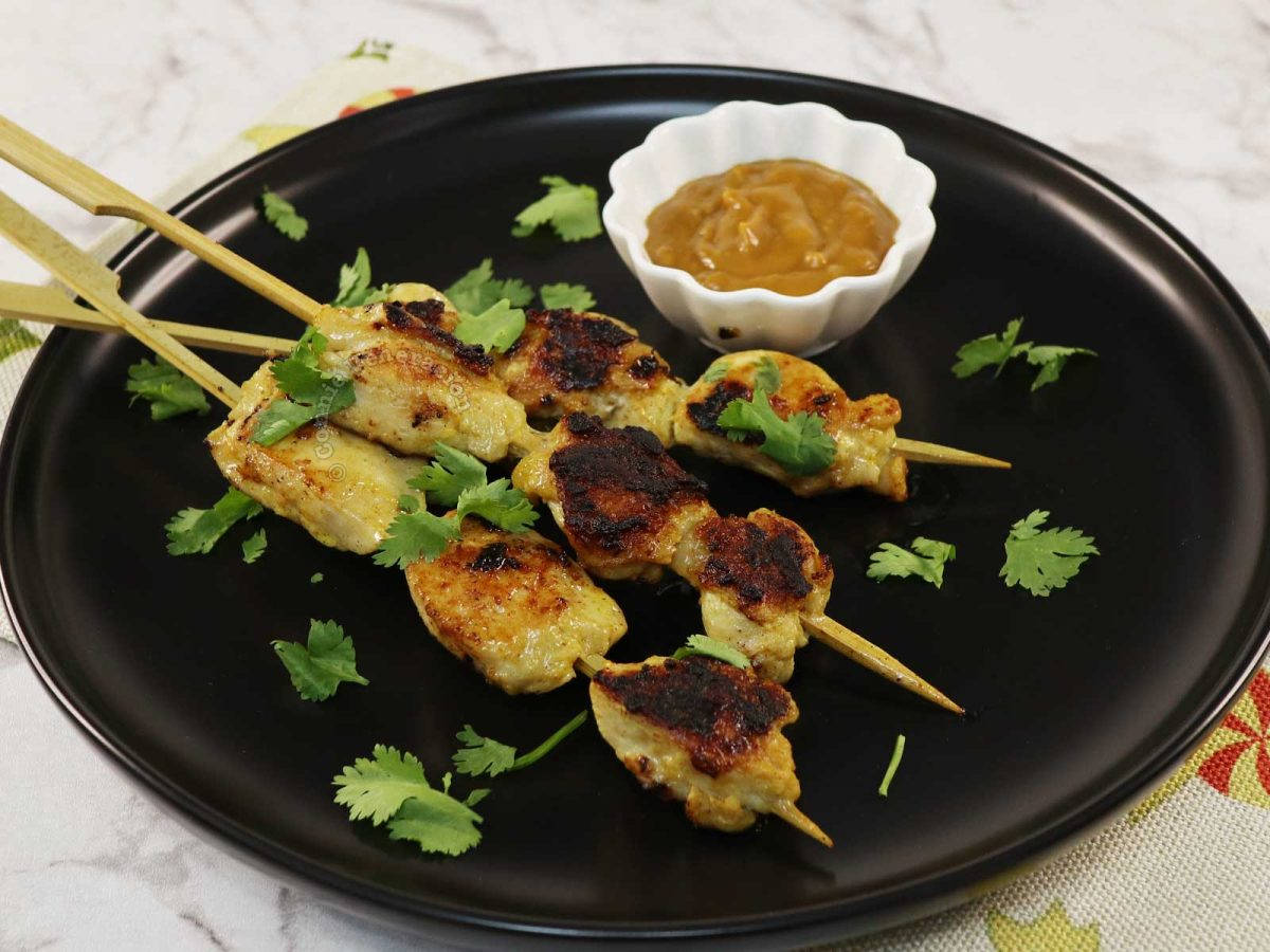 Savory Chicken Satay With Peanut Sauce And Fresh Coriander Background