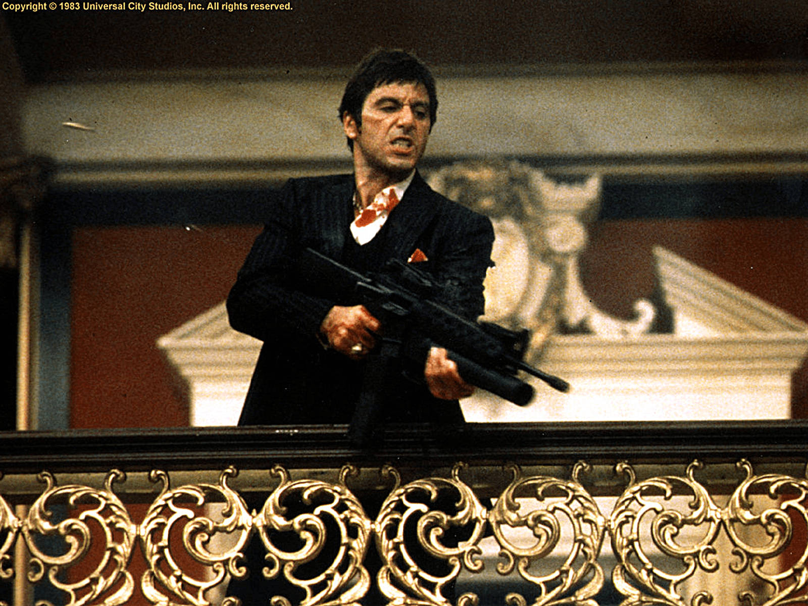 Scarface Holding A Gun Background