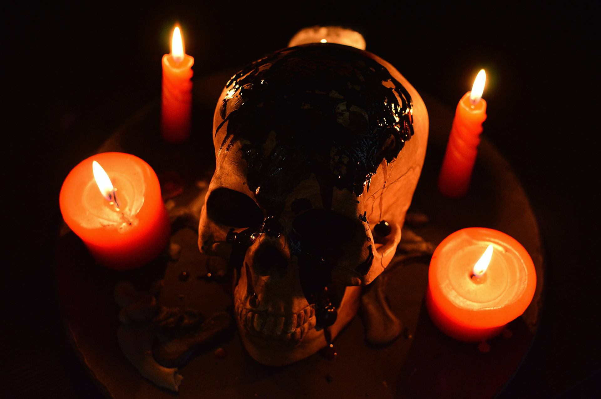 Scary Skulls And Lit Candles Background