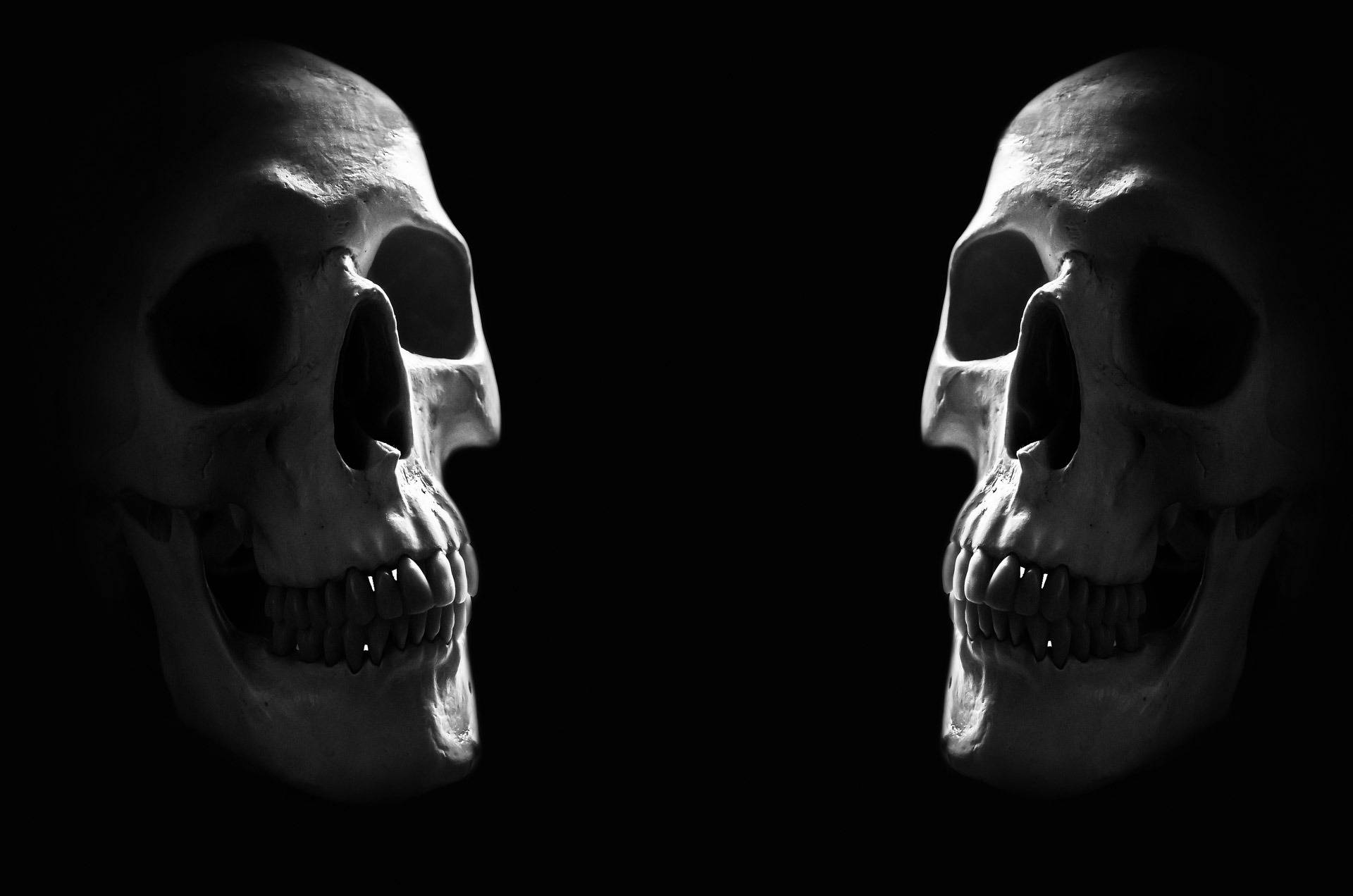 Scary Skulls In Darkness Background