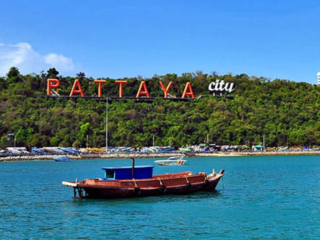 Scenic View Of A Traditional Boat Docking In Pattaya City Background