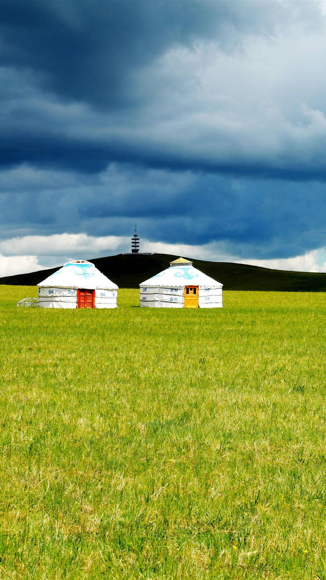 Scenic View Of Traditional Mongolian Yurts On Vast Plains Background